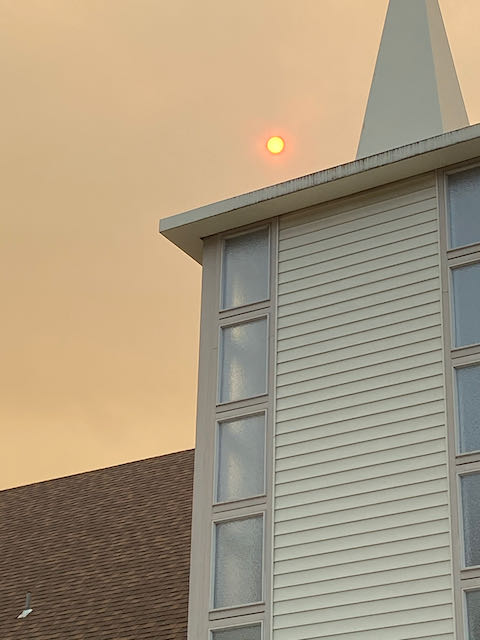 Orange sun over church